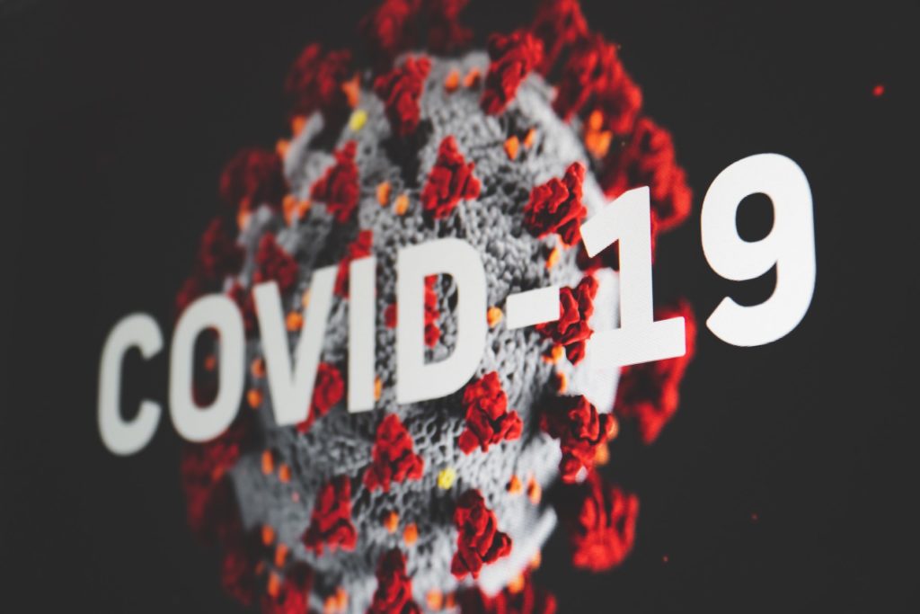 Image of the Covid-19 virus and the words Covid-19